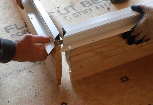 The frame’s upper corners are sealed with silicone before assembly. Once screwed together, this corner should be wrapped with a peel-and-stick flashing to ensure a tight water seal.