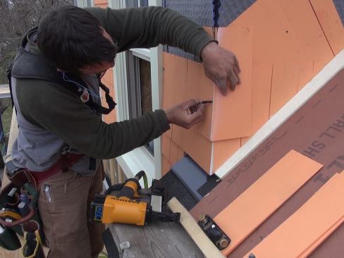 Pollard marks the back side of a corner shingle for a matching weave cut.
