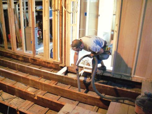 As you can imagine, dirt and debris from several decades had accumulated in the spaces between the joists, along with loose cellulose insulation that had been added at one point. To give me a clean starting point, I vacuumed the bays thoroughly as I tore out the old subfloor.