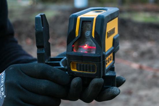 When our last laser plumb bob died, we suddenly realized how often we reached for it and how much time it had been saving us. We replaced it with a 
DeWalt DW0822 which we’ve been using all year with no complaints. It is as good as any we’ve used, and sells for a reasonable price. This type of tool is a must-have for us because we frame a lot of tall walls and rakes; we routinely need to plumb 20-foot walls. Another common use is for transferring layout onto ceilings. The tool also projects a level line, which is handy for hanging a series of windows or shooting level for porch columns.