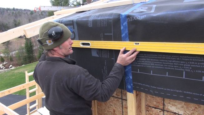 Checking the soffit ledger layout line for level.