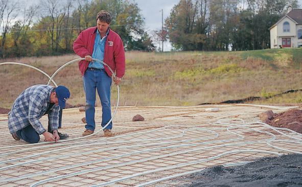 On an asphalt job, the PEX is protected with a layer of stone dust (foreground).