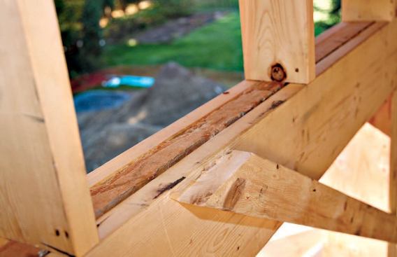 Structural headers are packed with foam board to create a thermal break.