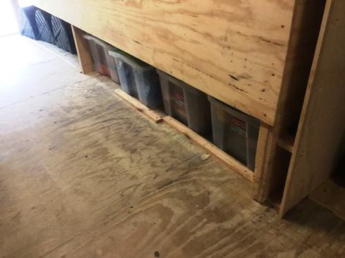 The console stops short of the floor, and the space below is used to store are plastic bins containing extension cords, PVC electrical boxes, and collated nails. Those black things near the ramp are Coil Tamers, hinged plastic containers that hold and dispense the coil stock for the brake. They keep the stock tightly coiled and prevent it from being damaged—and they won’t fall apart like the cardboard boxes.