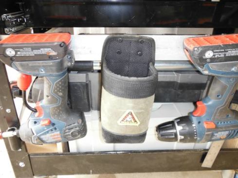 The last thing I did was attach flat aluminum bar (1/8” x 2”) to three sides of the cart so I could hang things with belt clips from it – in this case a cordless impact and drill/driver and a coffee cup holder from Iron Dog Tool Gear. Iron Dog makes a number of bags and tool holders that can be clipped onto a tool belt or carrier (or the bars on my cart). I seldom wear bulky tool belts but do like the holders. You’ll see a variety of Iron Dog holders in other photos of the cart. I like them because they can be removed and relocated at will.