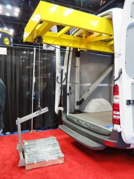 Weightlifter makes lifts for trucks and vans. This is their newest van model, which is so new it doesn’t have a name. Powered by electricity and hydraulics it is capable of lifting more than 1,000 pounds. It installs using existing holes in the floor of the van and can be configured to fit many makes and models. 
Click here to see this gizmo in action.