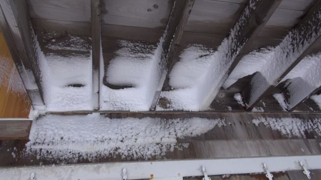 Rime ice and wind-driven snow coat the underside of the porch roof. Freezing weather and more snow continued to hammer New England after the January blizzard.