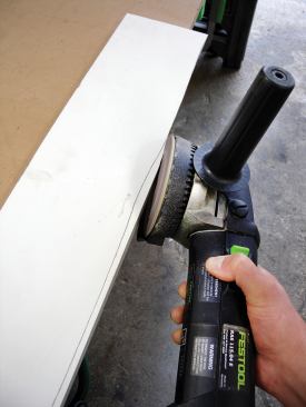A Festool RAS 115 sander is as fast as an angle grinder but has a dust-collection system that captures most of the dust.