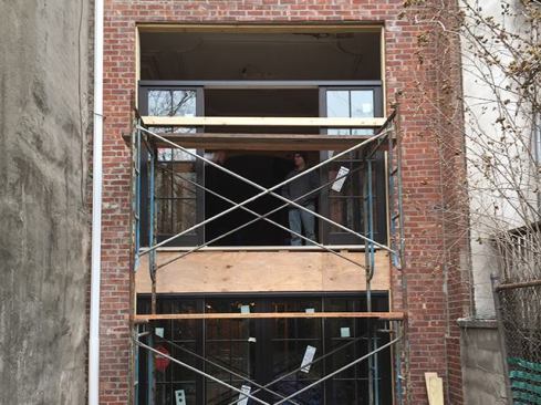 With the garden-level door installed, we moved on to the kitchen slider. The first-floor ceiling height allowed for an 18-inch-high finished transom above the door, which helped bring in more natural lighting.