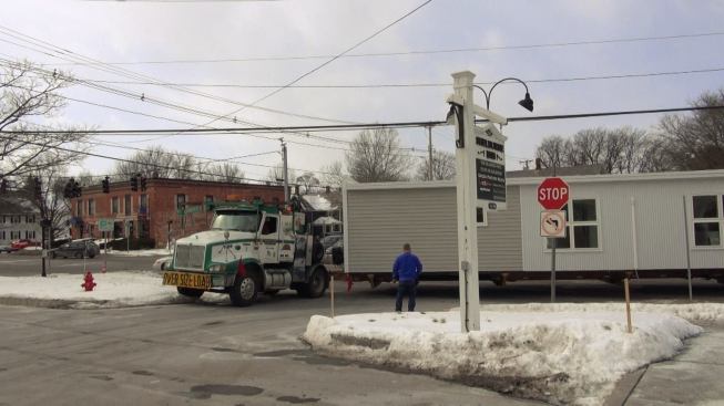 After a 96-mile highway trip, the VerMod home makes its turn off the road into the driveway of a trailer park in Shelburne, Vermont, under the watchful eye of Steve Davis.
