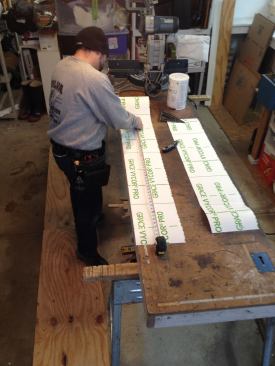 Before the old window is even removed, work begins in the warm confines of the shop where Manny pre-cuts all the lengths of flashing tape that he will need.