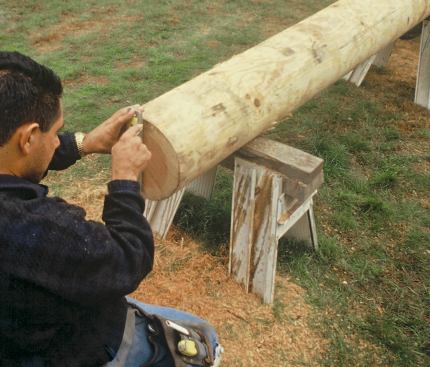 All layout on logs springs from a centerline. To find it, a plumb line is drawn through the center of each end of the log.