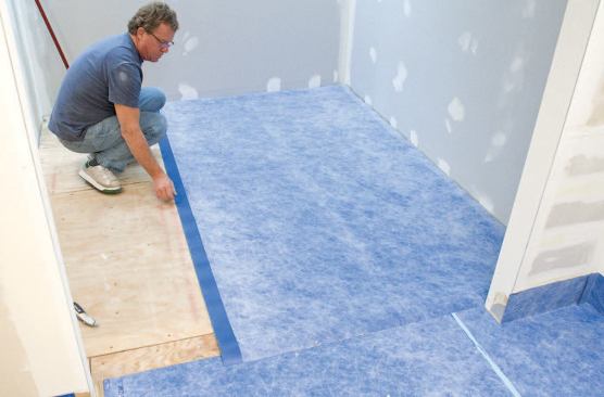 To speed up sheet membrane installation, the author cuts, dry-fits, and folds all sections before applying adhesive. First, he positions the cut sheet.