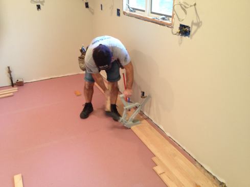 For this floor, the first three courses had to be installed before there was enough room to use the nailer. While not a problem with these walls that will be covered with cabinets, floor nailers are notorious for marring or damaging walls, so be careful when working close by.