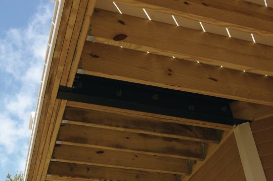 Pressure-treated 2x12s were used for the perimeter and infill joists, as well as for the ledger bolted to the house’s rim joist. Adjacent joists and the rim beam were bolted to the steel.