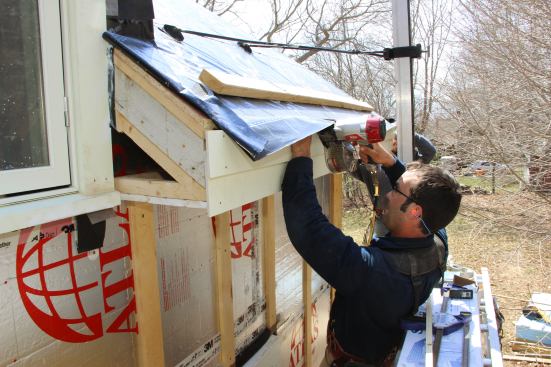 The outer top corner of the shadow board is positioned in plane with the roof sheathing and fastened with 8d stainless steel ring-shank nails.