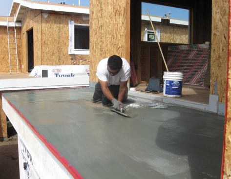 A multilayer cementitious coating provides a walkable waterproof surface with a Class A fire rating.