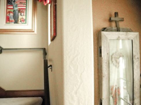 Blistered paint on the staircase's return wall