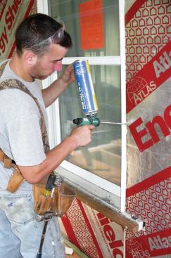 The walls were wrapped with 1-inch-thick sheets of polyisocyanurate foam, which adds R-6 to the wall assembly and acts as an air and vapor barrier and drainage plane. All joints — including gaps between the rigid foam and jamb extensions — were foamed.