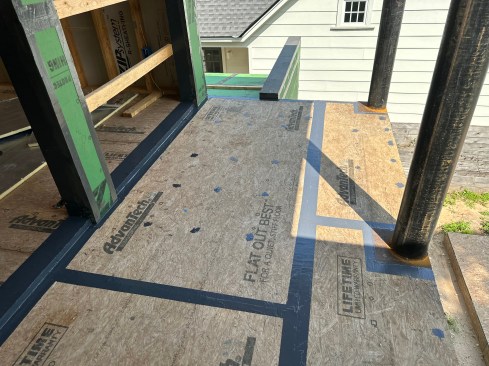 Instead of using metal pans, the author creates sill pans using fluid-applied. Note: Seams in the porch deck are also sealed with fluid-applied. 