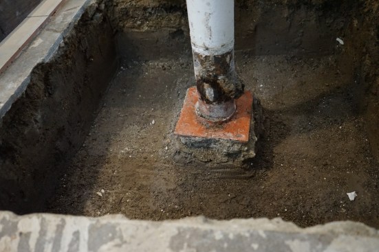 A column supporting the existing girder in the basement had almost no footing.