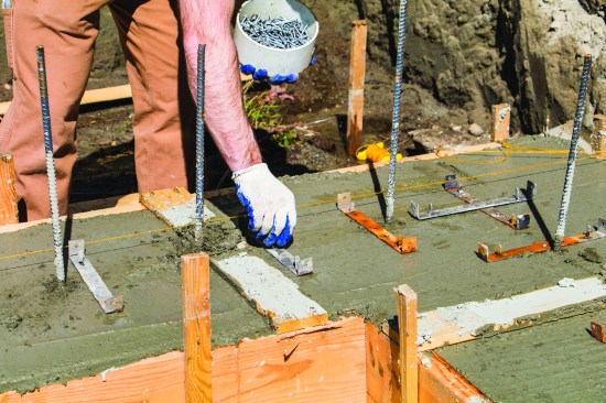 After footings were poured, cleats were installed on the green concrete with “Teco” nails.