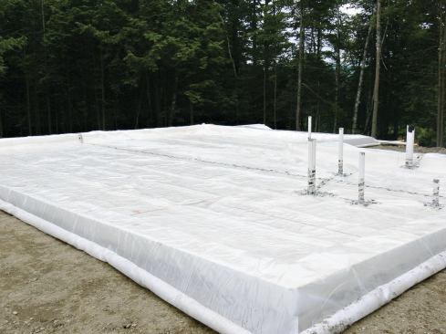 A sheet of 10-mil poly, which acts as an air and vapor barrier and a capillary break, was laid on top of the EPS.