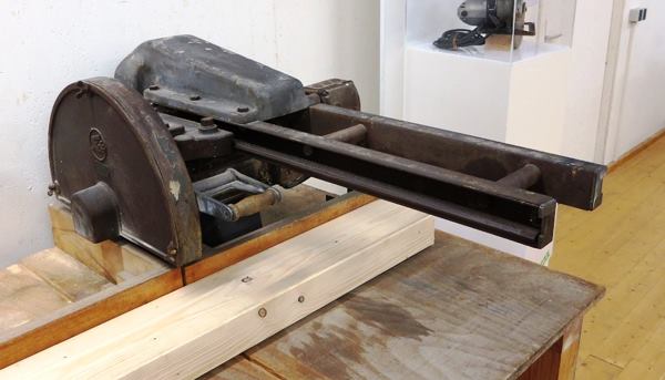 You’re looking at a radial arm saw stripped to the basics: a motor, a blade, and an extremely beefy set of rails.