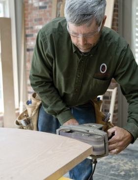 The cut is smoothed with a belt sander.