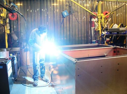 The largest boxes are assembled in a work cell known as the 2 man area. This fellow is assembling a model 119 Field Station. 
Click here for video.
