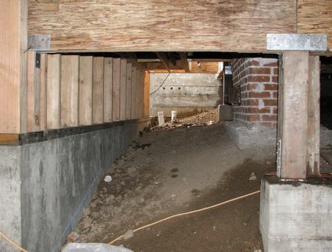 The new reinforced wall would serve as the back wall of the downstairs living space and permanently stabilize the soil under the house.