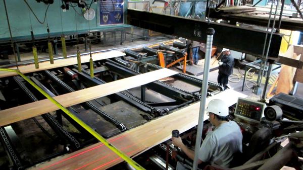 The log comes out of the band saw rig as a series of wide boards and is sent to the edger for ripping. It’s the edgerman’s job to position the boards (
video here) and set the blades inside the saw to rip nominal width pieces. Like the sawyer, he must optimize value by producing long lengths in desirable widths with the least amount of sapwood, knots, and other defects. The edgerman can position the blades on the fly and uses laser beams to see where they will hit the board.