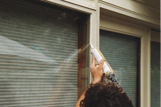 To prevent water from running behind the glazing trim, the author caulks this joint around all four sides of each window, paying particular attention to the bottom rail, where water intrusion is most likely.
