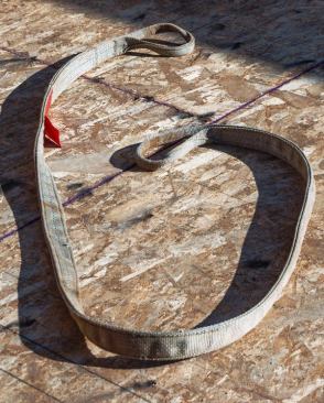Rigging Straps. We keep 10’, 20’, and 30’ rigging straps on hand to stand walls and lift beams. Load ratings are listed on the straps. We get rid of them when they start to fray. We get our straps from the local Whitecap Supply.