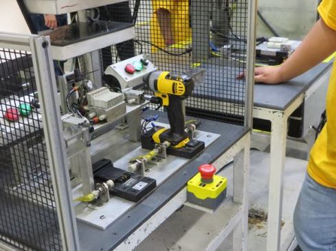 This impact driver is in the machine that programs the memory chip. It is held in position by sliding it on to fitting similar to that on the top of a 20V MAX battery.
