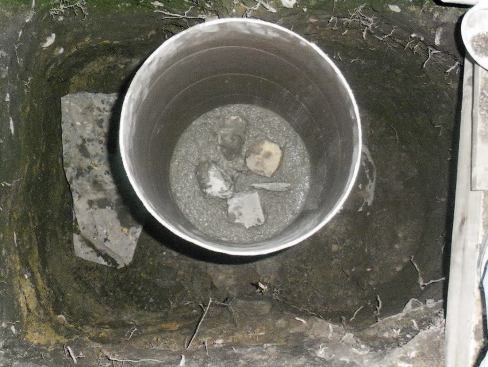 As I fill the tube, I add in clean rock, careful to keep it in the middle of the pier so there are no voids on the outside surface.