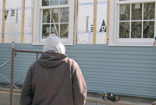 The fiber-cement siding was custom- ripped to allow narrower courses and tighter stacking at the base of the wall.