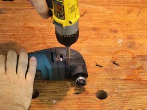 Remove the plastic housing (Makita calls it the head cover) from the front of the tool.