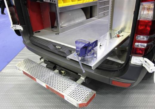 Many companies offer steps for getting into and out of work vans. I particularly like this hitch mounted model from Spec Techno because it’s easily removed and yet feels very solid. The mounting plate for the vise is cool too; it slides down for use and folds away for travel.
