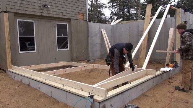 Hill begins to frame the new wall, starting with the window opening.