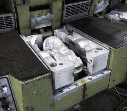 These forms will close around the upper just before the polyurethane is injected. The bottom will contain a rubber outsole (sole), the sides will close in against the upper, and the toe cap shaped piece will close over the top.