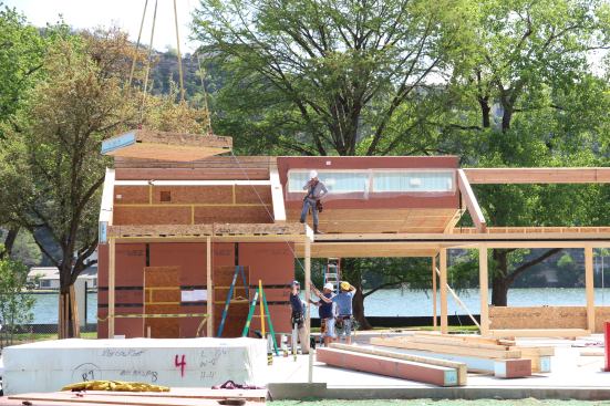 Bensonwood Timberframe house with SIPs using Zip Wall. Crane flying in a roof panel here.