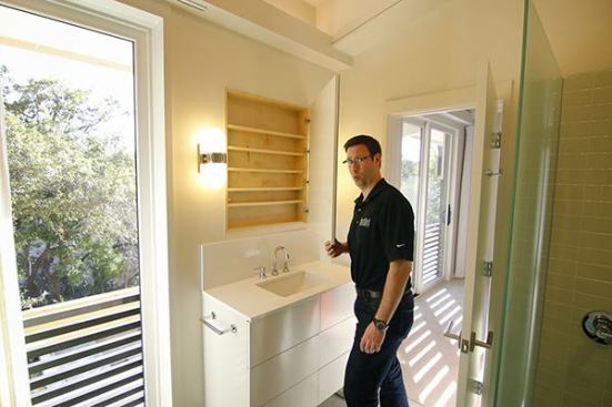 We used 4 Euro Style cabinet hinges on the MDF Medex slab then glued the mirror on.