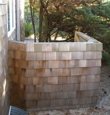 A simple barrier lined with acoustic blankets will absorb and block most of the noise produced by this AC condenser.