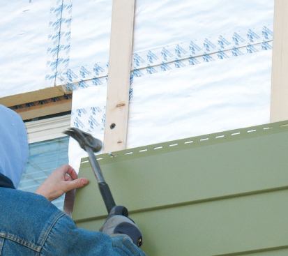 The cellular PVC siding had to be carefully hand-nailed through slots that allow for expansion.