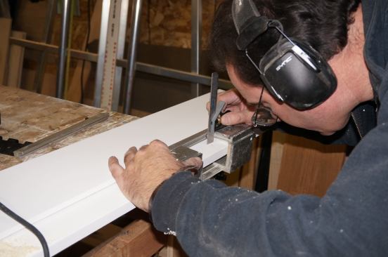 A small combination square registered against the jig lines up with the mark from the story pole. This allows Greg to position the mortises accurately.