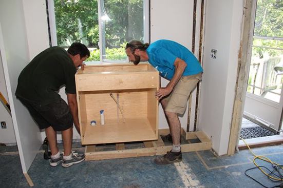Now it’s time to set the sink cabinet onto the leveled toe-kick base.