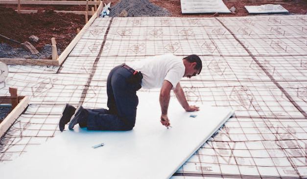 After the crushed stone base is spread and compacted, 1-inch extruded polystyrene board is laid over the entire snowmelt area.