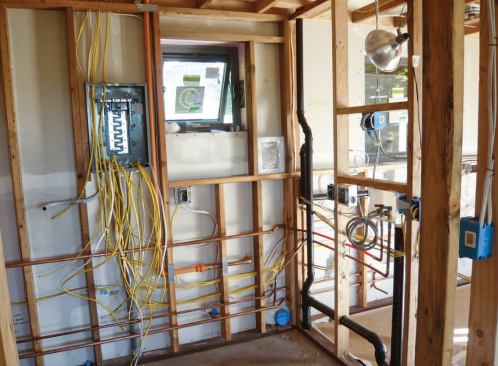 A furred-out wall on the north side of the kitchen and utility room — completely within the air-sealed thermal envelope — made it possible to run pipes and wiring as needed without additional air-sealing or insulation.