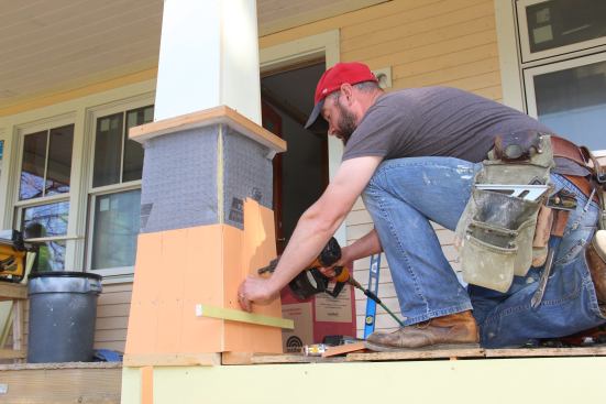 Fenton attaches a shingle using stainless steel staples.